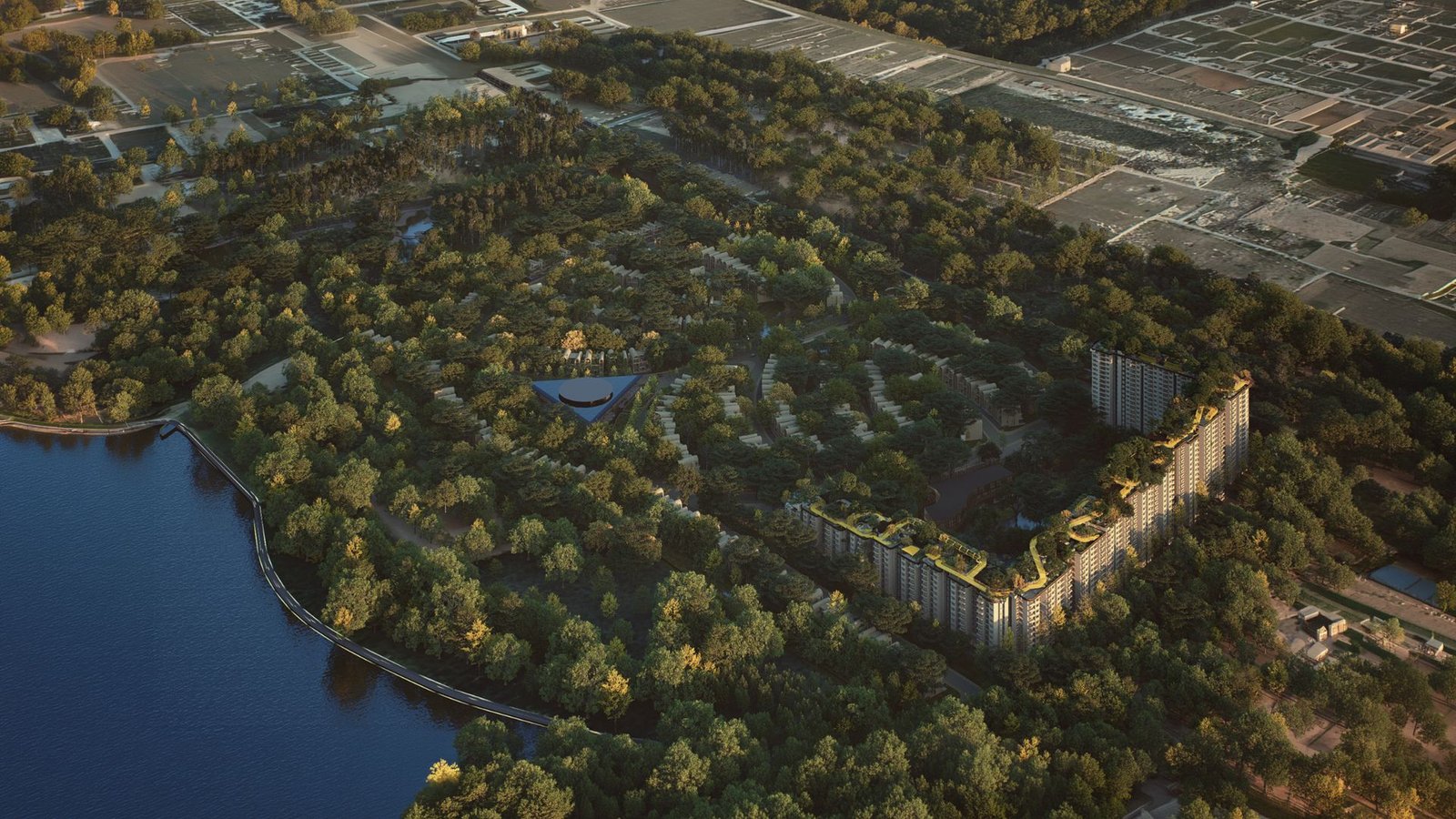 Aerial view of the development with dense tree cover beside a lake