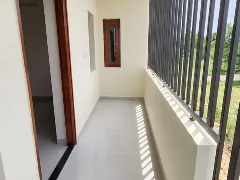 First-floor corridor with bar railing and patterned tile border, Villa 1