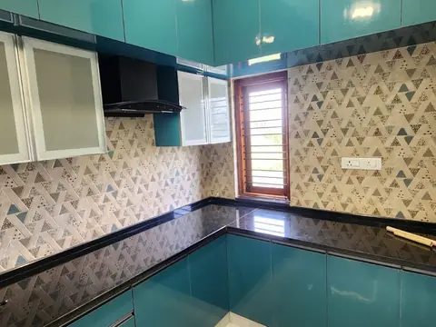 Kitchen with electric chimney, glass-front cabinets and patterned backsplash, Villa 1