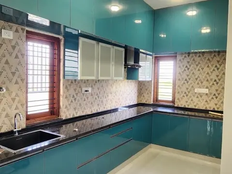 L-shaped kitchen with teal cabinets and drawers, Villa 1