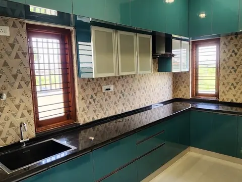 Fitted kitchen with teal cabinets and black granite counter, Villa 1