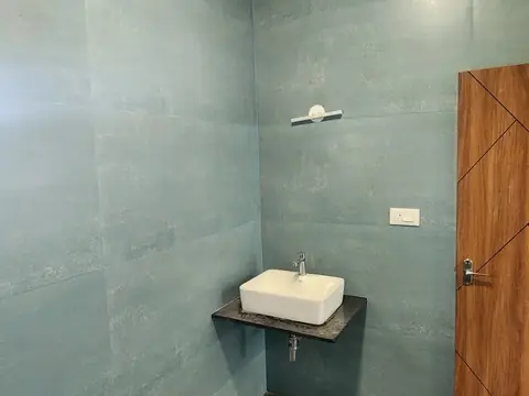 Attached bathroom with teal-grey tiles and counter-top basin, Villa 2