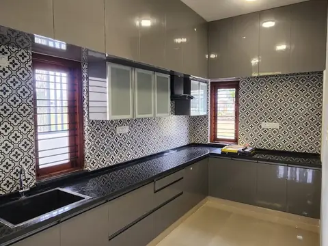 L-shaped kitchen with grey cabinets and black granite counter, Villa 2