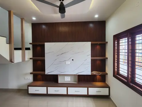 Living room TV wall with wooden shelves and marble-look panel, Villa 2