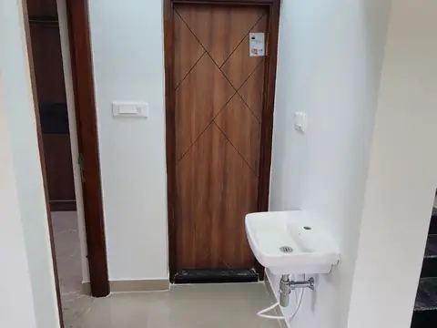 Passage with wash basin and wooden door, Villa 2
