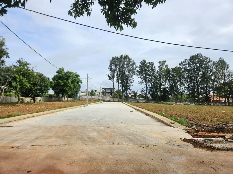 Concrete approach road beside the plot in Yelahanka